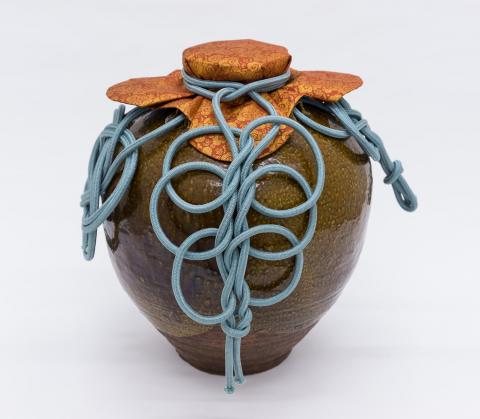 Tea leaf storage jar called "Chigusa" dressed with silk cord and mouth cover
